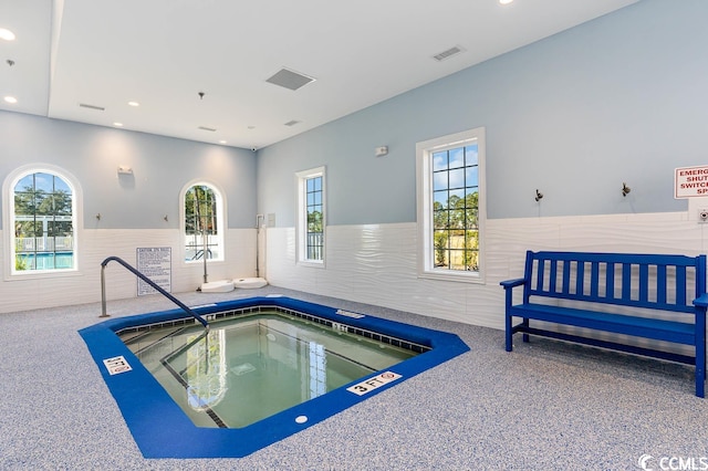 view of pool with an indoor hot tub