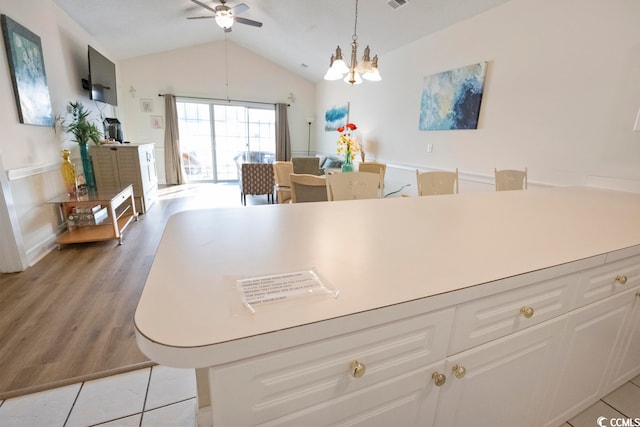 4856 Carnation Cir Unit 304, Myrtle Beach, SC 29577 - kitchen with lofted ceiling, hanging light fixtures, white cabinetry, ceiling fan with notable chandelier, and light hardwood / wood-style flooring
