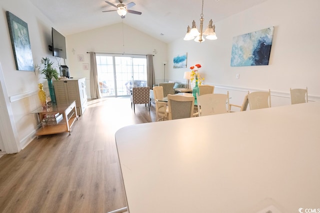 4856 Carnation Cir Unit 304, Myrtle Beach, SC 29577 - dining area with ceiling fan with notable chandelier, vaulted ceiling, and light wood-type flooring