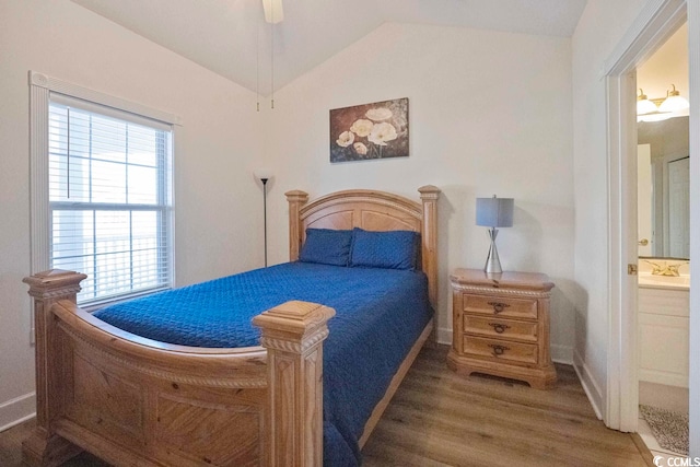 4856 Carnation Cir Unit 304, Myrtle Beach, SC 29577 - bedroom featuring multiple windows, lofted ceiling, dark wood-type flooring, and ensuite bath