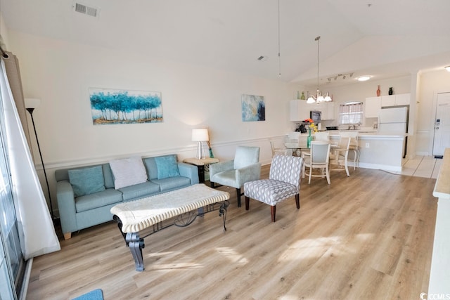 4856 Carnation Cir Unit 304, Myrtle Beach, SC 29577 - living room featuring light wood-type flooring, a chandelier, and vaulted ceiling