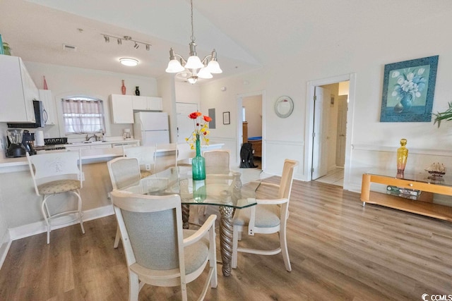 4856 Carnation Cir Unit 304, Myrtle Beach, SC 29577 - dining area with an inviting chandelier, sink, and light hardwood / wood-style flooring