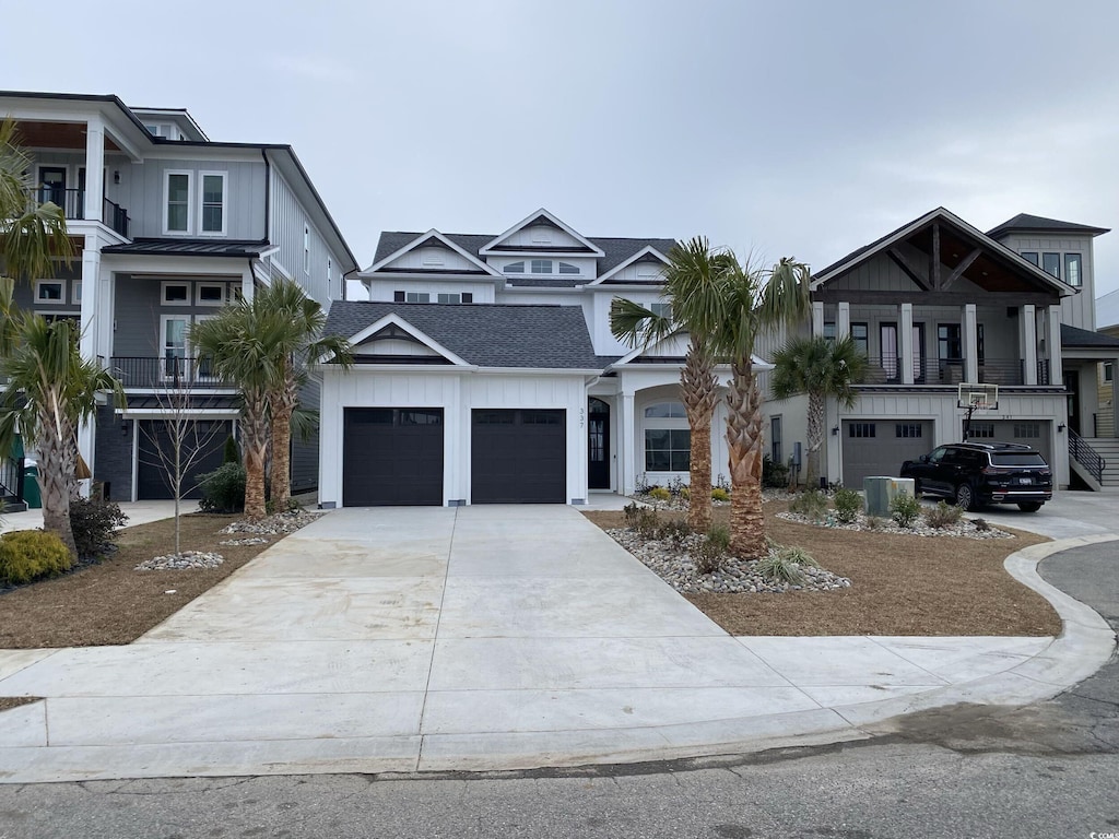 view of front of property with central AC and a garage