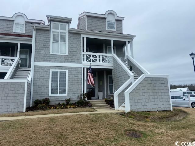 view of front facade with a front yard and a porch