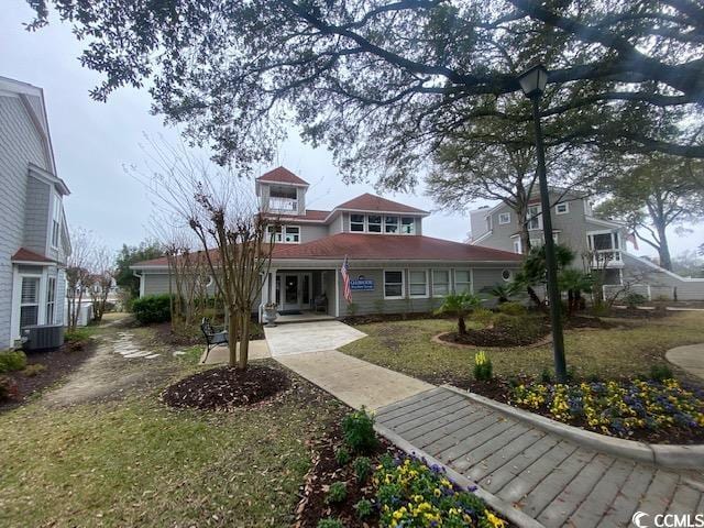 view of front of property featuring a front yard and central AC unit