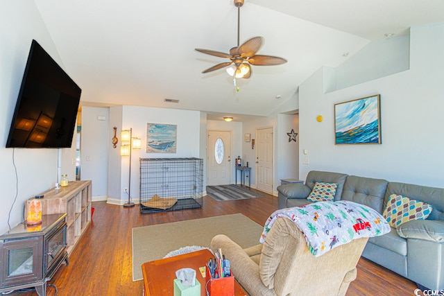 living room featuring vaulted ceiling, ceiling fan, and dark hardwood / wood-style floors