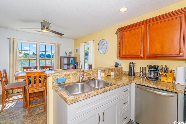 kitchen with white cabinets, ceiling fan, kitchen peninsula, dishwasher, and sink