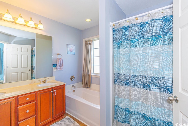 bathroom with a bathing tub and vanity