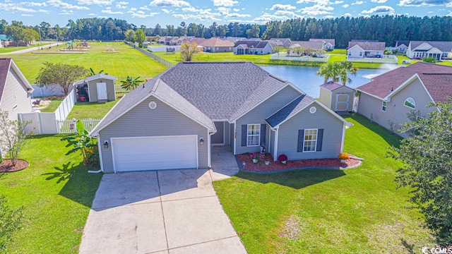 view of front of house featuring a shed, a front yard, and a garage