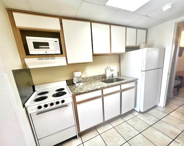 kitchen with sink, white appliances, white cabinetry, and light stone counters