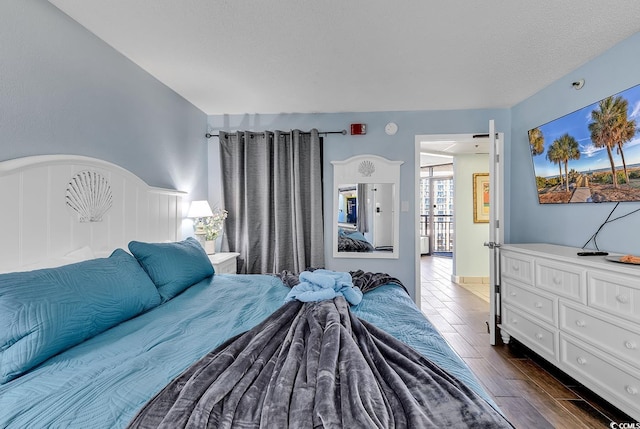 bedroom with wood tiled floor and a textured ceiling