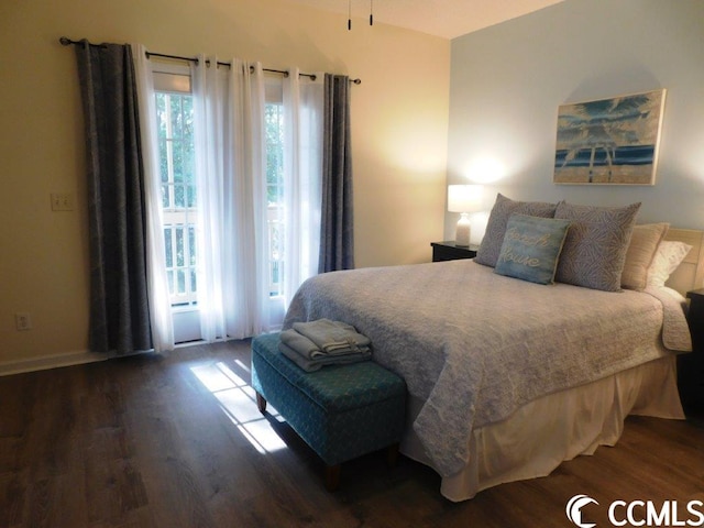 bedroom featuring dark hardwood / wood-style floors and multiple windows