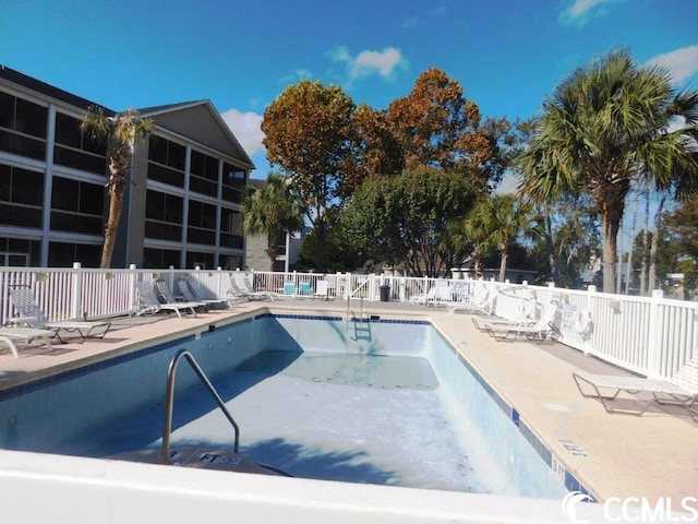 view of swimming pool with a patio area