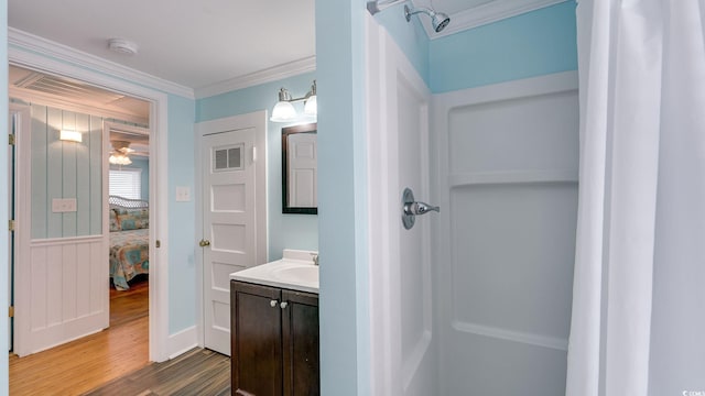 full bath with visible vents, connected bathroom, ornamental molding, wood finished floors, and vanity