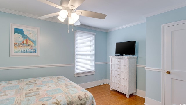 bedroom with baseboards, ceiling fan, light wood-style floors, and crown molding