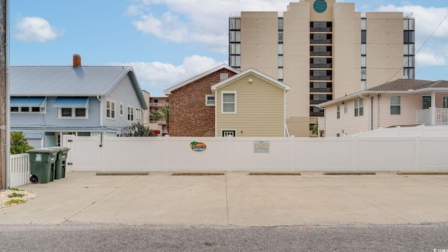 exterior space featuring uncovered parking and fence