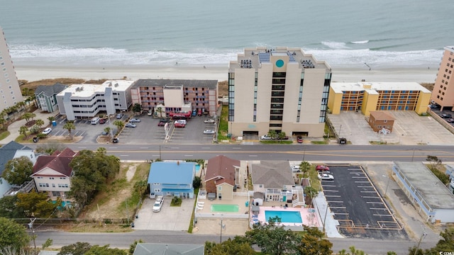 drone / aerial view with a water view and a beach view