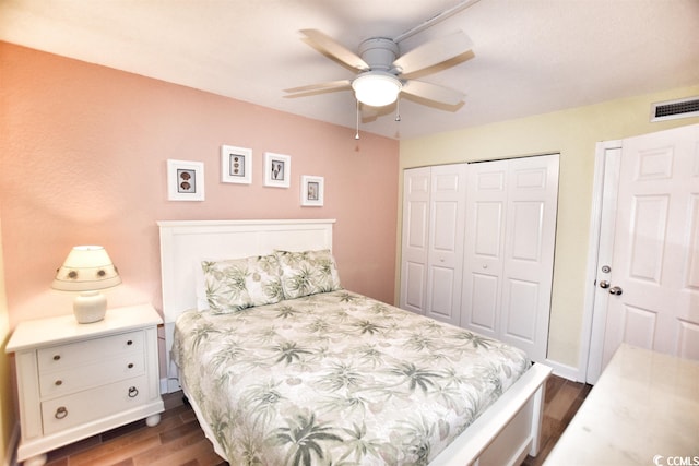 bedroom with dark hardwood / wood-style flooring, a closet, and ceiling fan