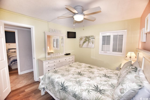 bedroom with light hardwood / wood-style flooring and ceiling fan