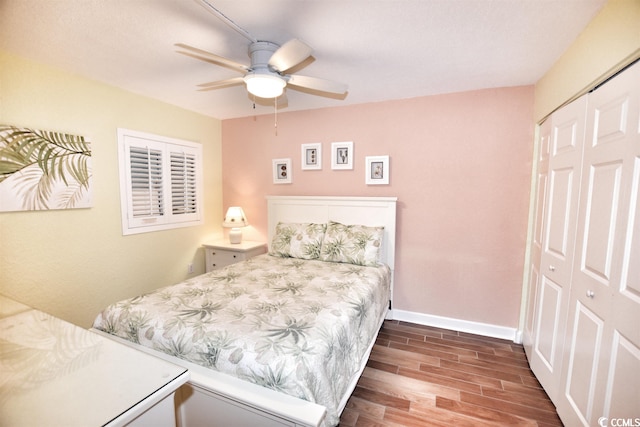 bedroom with dark hardwood / wood-style floors, a closet, and ceiling fan