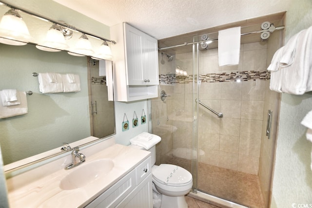 bathroom with vanity, an enclosed shower, a textured ceiling, and toilet