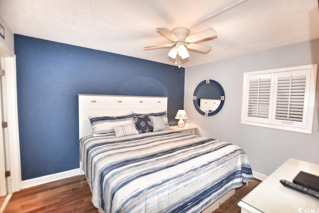 bedroom featuring ceiling fan and dark hardwood / wood-style flooring