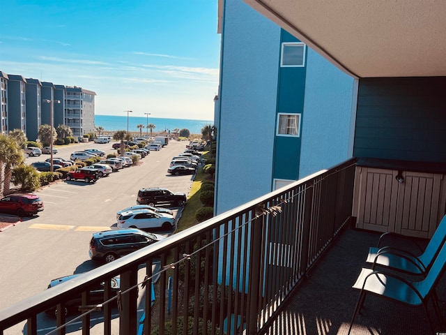 balcony featuring a water view