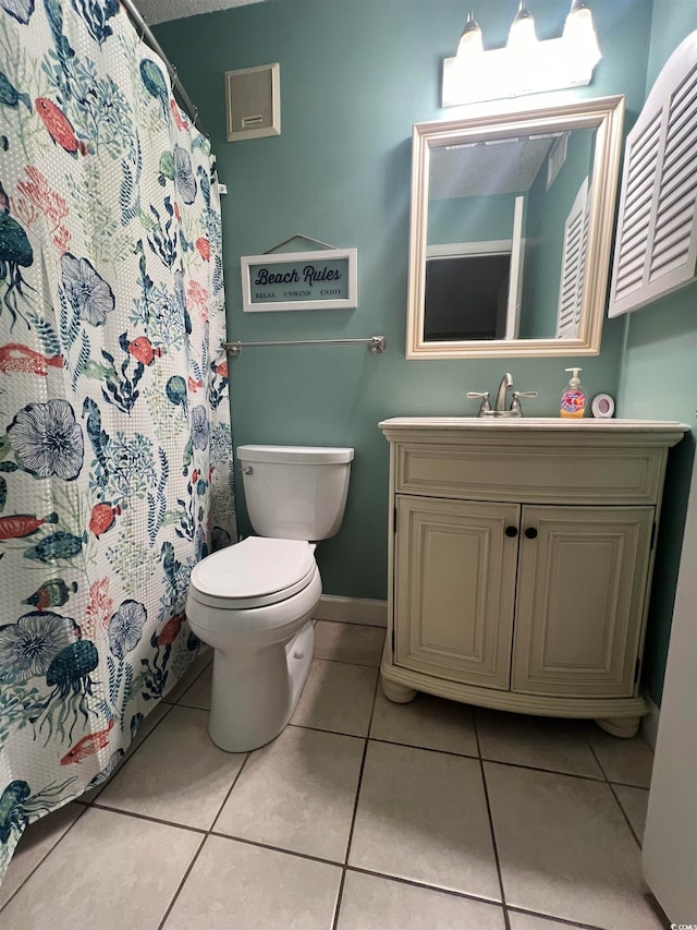 bathroom with vanity, toilet, a shower with shower curtain, and tile patterned flooring