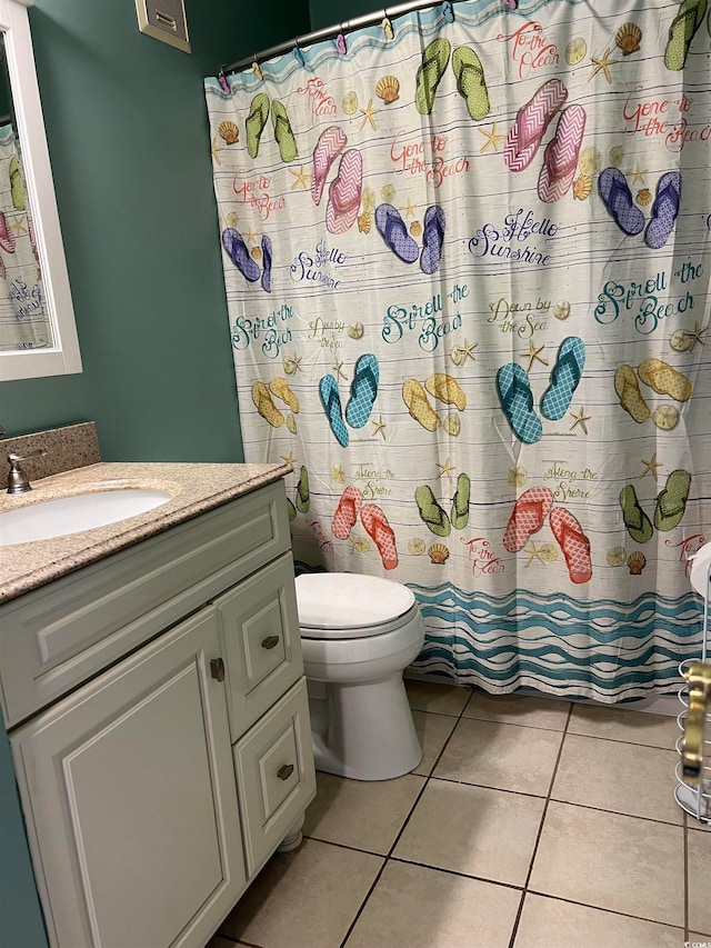 bathroom featuring vanity, toilet, curtained shower, and tile patterned floors