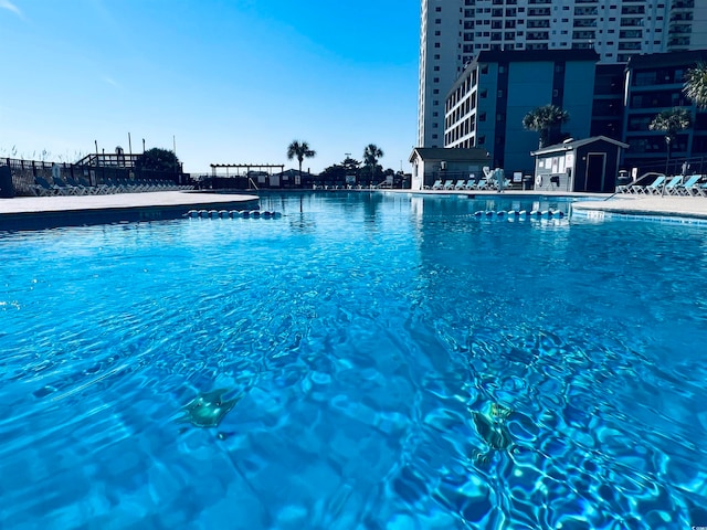 view of swimming pool featuring a water view