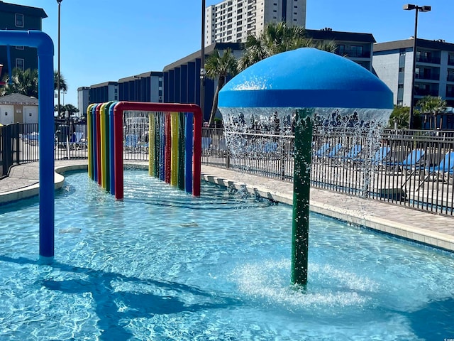 view of swimming pool featuring a playground