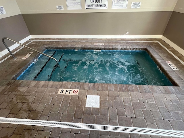 view of pool with an indoor in ground hot tub