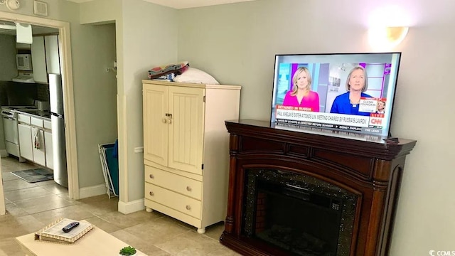 interior space featuring white range and stainless steel refrigerator