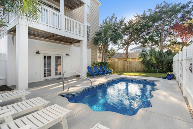 view of pool with french doors and a patio