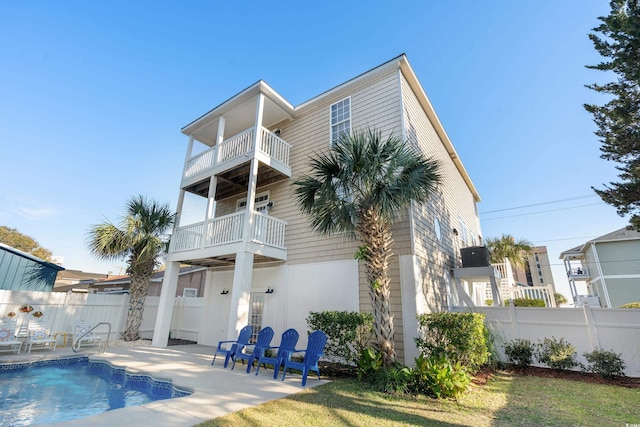 view of pool with french doors and a patio