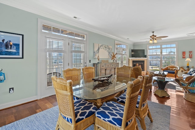 living room with ornamental molding, hardwood / wood-style floors, and ceiling fan