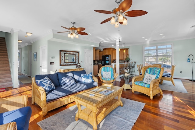 living room with ornamental molding, hardwood / wood-style floors, a fireplace, and ceiling fan