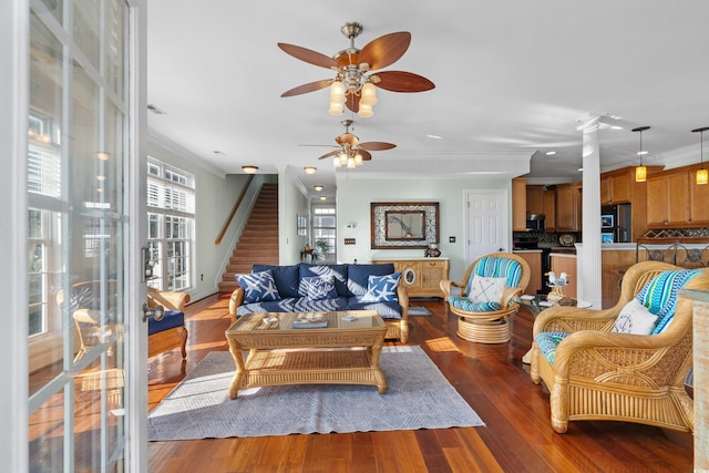 living room featuring crown molding, dark hardwood / wood-style flooring, and ceiling fan