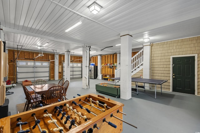 garage featuring a garage door opener and wooden walls