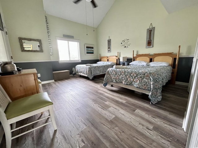 bedroom featuring wood-type flooring, high vaulted ceiling, and ceiling fan