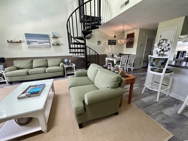 living room with a notable chandelier and hardwood / wood-style flooring