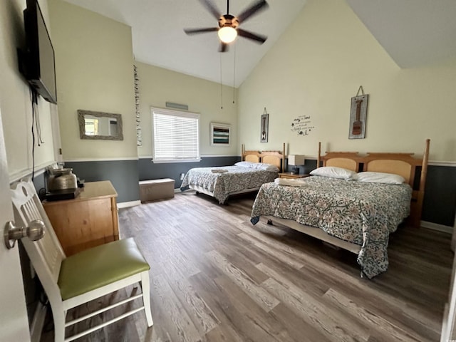 bedroom featuring hardwood / wood-style flooring, high vaulted ceiling, and ceiling fan