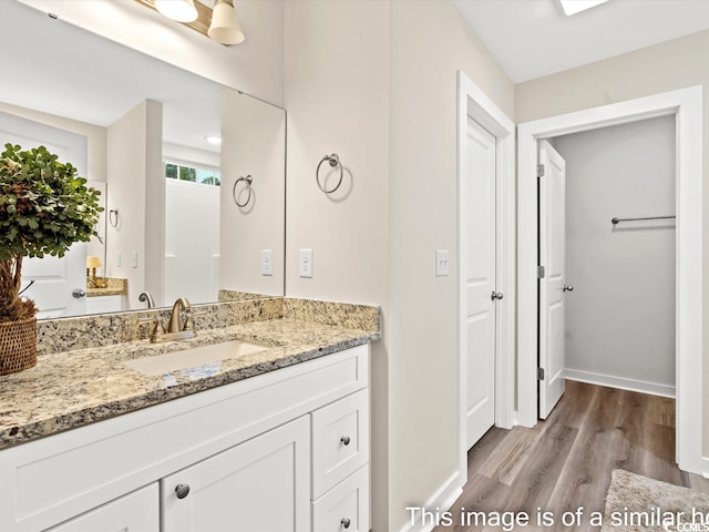 bathroom featuring wood-type flooring and vanity