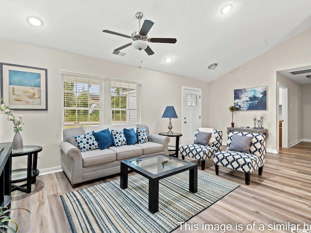 living room with ceiling fan, lofted ceiling, and light hardwood / wood-style flooring