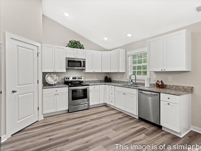 kitchen featuring light hardwood / wood-style floors, white cabinetry, sink, and stainless steel appliances