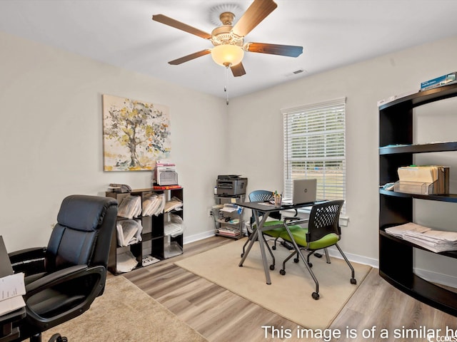 office space featuring light hardwood / wood-style floors and ceiling fan