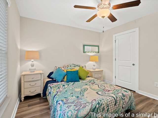 bedroom with ceiling fan and dark wood-type flooring