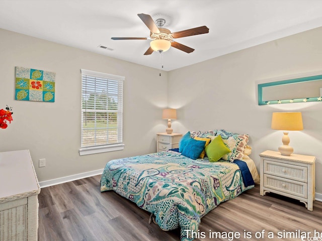 bedroom with wood-type flooring and ceiling fan