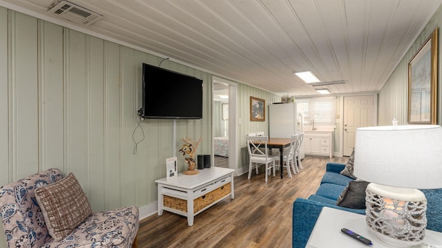 living room featuring wood finished floors and visible vents