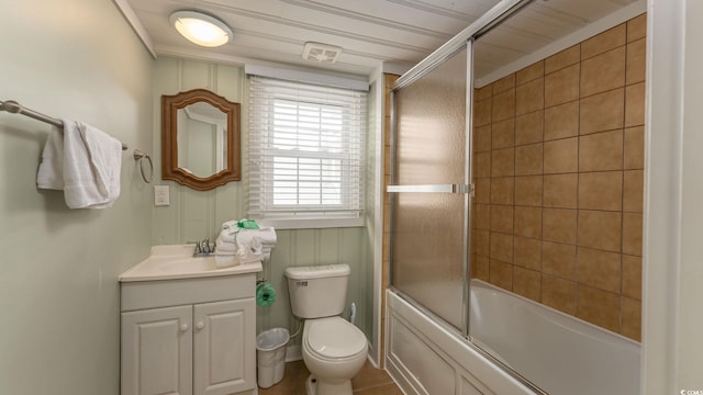 full bath with combined bath / shower with glass door, vanity, and toilet